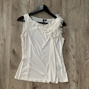 Off white tank  blouse with decal on shoulder.